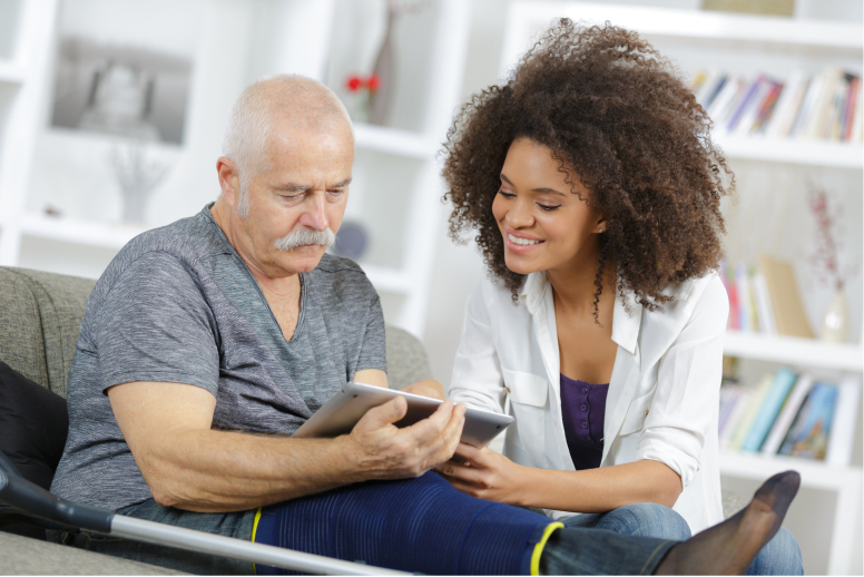 Female Pharmacist Helping Male Senior on Tablet