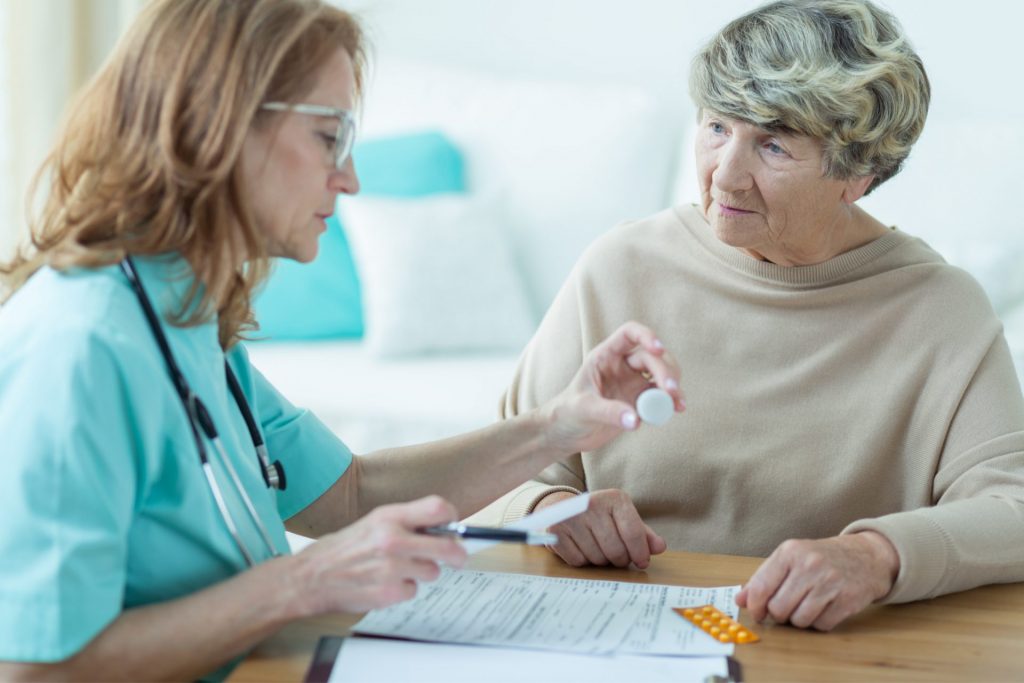 Doctor Having Conversation with Senior About Medication